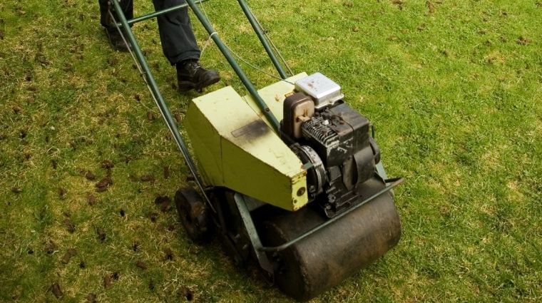 A small aeration machine being used to aerate a lawn. 